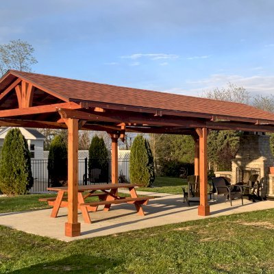 Del Norte Outdoor Kitchen Pavilion (Options: 30' L x 14' W, California Redwood, 6-Post Anchor Kit for Concrete, 1 Ceiling Fan Base, 2 Electrical Wiring Trim Kits, No Post Decorative Trims, Transparent Premium Sealant). Photo Also Shows a Forever Picnic Table. Photo Courtesy of M. Luebke of Front Royal, Virginia.