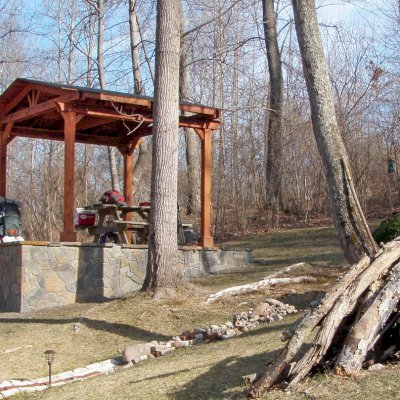 Del Norte Outdoor Kitchen Pavilion (Options: 12' L x 12' W, Mature Redwood, Unattached, 4-Post Anchor Kit for Stone, No Electrical Wiring Trim, 9' Posts, No Ceiling Fan Base, No Privacy Panels, No Curtain Rods, Transparent Premium Sealant). Photo Courtesy of Lisa K.  & Peter S. of Lexington, VA.