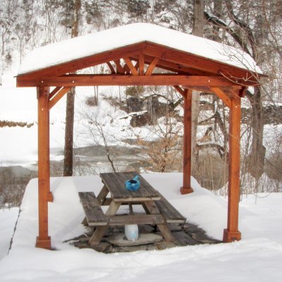 Del Norte Outdoor Kitchen Pavilion (Options: 12' L x 12' W, Mature Redwood, Unattached, 4-Post Anchor Kit for Stone, No Electrical Wiring Trim, 9' Posts, No Ceiling Fan Base, No Privacy Panels, No Curtain Rods, Transparent Premium Sealant). Photo Courtesy of Lisa K.  & Peter S. of Lexington, VA.