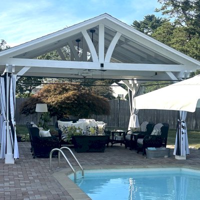 Del Norte Outdoor Kitchen Pavilion (Options: 15' L x 18' W, Mosaic Douglas-Fir, 4-Post Anchor Kit for Concrete, 9.5' H Posts, 1 Ceiling Fan Base, 1 Electrical Wiring Trim Kit, 4 Curtain Rods, White Stain Premium Sealant). Photo Courtesy of S. Leonard of Easton, MA.