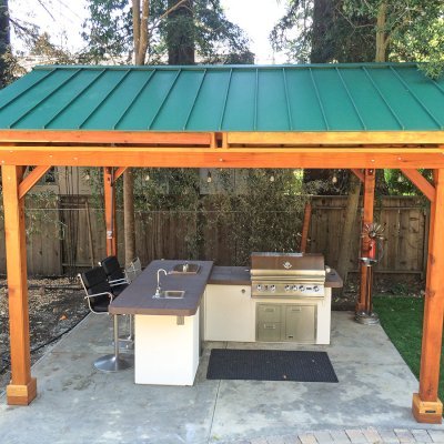 Del Norte Outdoor Kitchen Pavilion (Options: 16' L x 13' W, California Redwood, Unattached, 4-Post Anchor Kit for High-Wind, No Electrical Wiring Trim, 9' Posts, No Ceiling Fan Base, No Privacy Panels, No Curtain Rods, Transparent Premium Sealant). Standing Seam Metal Roof added by Customer Request. Photo Courtesy of Steve Aber of Atherton, CA.