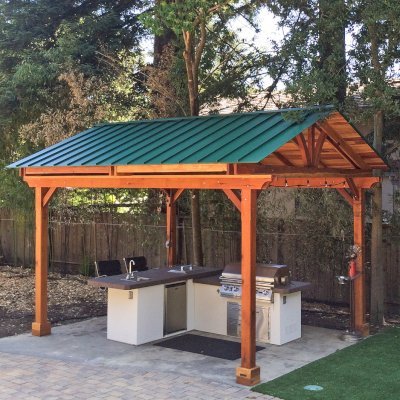 Del Norte Outdoor Kitchen Pavilion (Options: 16' L x 13' W, California Redwood, Unattached, 4-Post Anchor Kit for High-Wind, No Electrical Wiring Trim, 9' Posts, No Ceiling Fan Base, No Privacy Panels, No Curtain Rods, Transparent Premium Sealant). Standing Seam Metal Roof added by Customer Request. Photo Courtesy of Steve Aber of Atherton, CA.