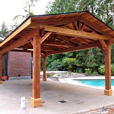 Custom Del Rio Cathedral Ceiling Thick Timber Pavilion (Options: 22' L x 15' W, California Redwood, 4-Post Anchor Kit for High-Wind, Electrical Wiring Trim for 2 Posts, 9.5' Posts, 1 Ceiling Fan Base, No Privacy Panels, No Curtain Rods, Transparent Premium Sealant). Photo Courtesy of S. Flanagin of Sammamish, Washington.