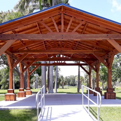 Custom Del Rio Cathedral Ceiling Thick Timber Pavilion (Options: 36' L x 24' Triangle Base W, No Privacy Panels, Douglas-fir, 10' ft Height, Electrical Wiring Trims for All Posts, With Custom Anchors and Hardware, Custom Trim Boxes at the Bottom of the Posts (Boots), 3 Ceiling Fan Bases, No Curtain Rods, Transparent Premium Sealant). This Pavilion can be seen at the South Florida Science Center, 4801 Dreher Trail N, West Palm Beach, FL 33405.