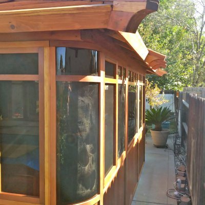 DIY Wood Gazebo (14' L, 12' W, California Redwood, All Sliding Windows with Screens, 4' x 6' Skylight, 36" H Siding Below Windows, Vertical Siding, Japanese Doors with Screens, No Flooring, Transparent Premium Sealant). Photo Courtesy of B. Adkisson of Sacramento, CA. XL Custom Roof per Customer Request.