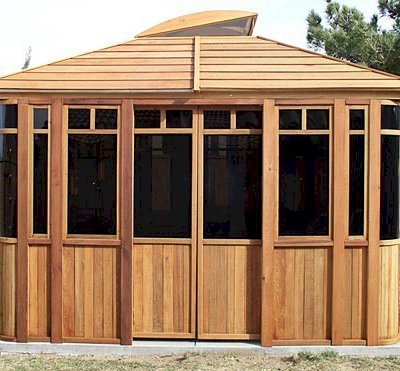 DIY Wood Gazebo (14' L, 12' W, Mature Redwood, Sliding Windows, 4' x 6' Skylight, 24" H Siding Below Windows, Vertical Siding, Japanese Doors, No Flooring, Transparent Premium Sealant). Custom detail: Roof overhang was minimized per customer request.
