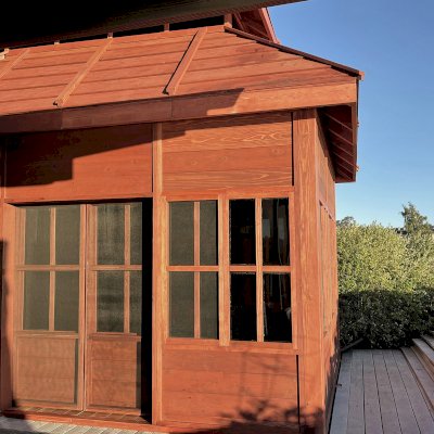 Dream Gazebos (Options: 9 ft Wall Height, 10' L, 14' W, Douglas-fir, All Sliding Windows with Screens, 4' x 6' Skylight, 36" H Siding Below Windows, Horizontal Siding, Japanese Doors with Screens, Complete Floor, Shiplap Roof, Cherry Stain Premium Sealant). Photo Courtesy of B. Victor of Larkspur, California.