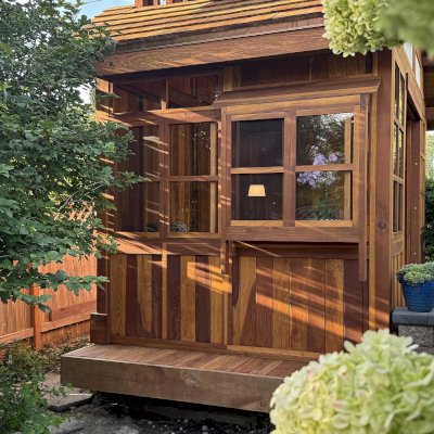 Custom Dream Gazebos (Options: 9 ft Wall Height, 10' L, 14' W, California Redwood, Combination of Sliding Windows with Screens and Fixed Windows, No Skylight, 36" H Siding Below Windows, Vertical Siding, Roof Pitch 8:12, Japanese Doors with Screens, No Floor [Installed on an Existing Deck], Shiplap Roof, Transparent Premium Sealant). Photo Courtesy of J. & R. Griess of Omaha, NE.
