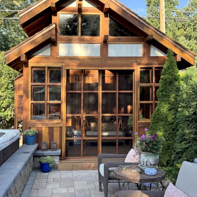 Custom Dream Gazebos (Options: 9 ft Wall Height, 10' L, 14' W, California Redwood, Combination of Sliding Windows with Screens and Fixed Windows, No Skylight, 36" H Siding Below Windows, Vertical Siding, Roof Pitch 8:12, Japanese Doors with Screens, No Floor [Installed on an Existing Deck], Shiplap Roof, Transparent Premium Sealant). Photo Courtesy of J. & R. Griess of Omaha, NE.