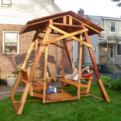 Dustin's Face to Face Glider after a hard day of assembly work (Options: California Redwood, Standard Roof, Without Beverage Armrest, No Kid's Platform/Sidetable, No Engraving, Transparent Premium Sealant). Photo Courtesy of Girish Sharma of Belleville, NJ.