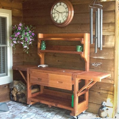 Eli's Redwood Potting Bench (Options: XL Size, Mature Redwood, Casters, 2 Shelves, Both Sides Fold Down, Copper Inset for Both Drawers, No Engraving, Removable Lid Over Right Drawer, Transparent Premium Sealant). Photo Courtesy of Linda Bond of Burkeville, Texas.