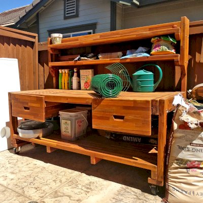 Eli's Redwood Potting Bench (Options: XXL Size, Mosaic Redwood, With Casters, No Fold Down Sides, No Cooper Inset, With Two Shelves, Removable Slatted Lid Over Left Drawer, Transparent Premium Sealant). Photo Courtesy of N. Cabaud of Brentwood, California.