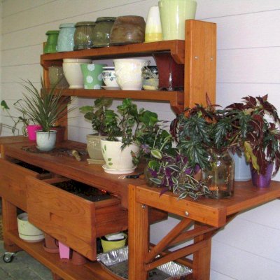 Eli's Redwood Potting Bench (Options: XL Size, Mature Redwood, Casters, 2 Shelves, Both Sides Fold Down, Copper Inset for Both Drawers, No Engraving, Removable Slatted Lid Over Left Drawer, Transparent Premium Sealant). Photo Courtesy of Leslie Hanna of Reston, Virginia.