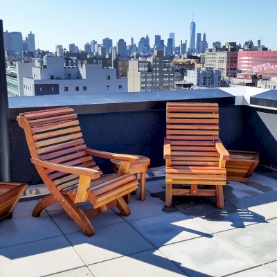 Ensenada Wood Easy Chair (Options: Standard Size, California Redwood, No Cushion, No Ottoman, Transparent Premium Sealant). Photo also shows 2 Tapered Planters and a Round Side Table. Photo Courtesy of Abe G. of Brooklyn, NY. 