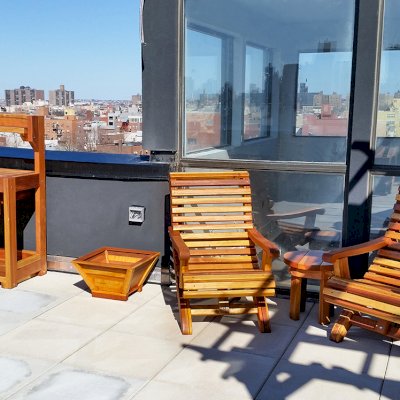 Ensenada Wood Easy Chair (Options: Standard Size, California Redwood, No Cushion, No Ottoman, Transparent Premium Sealant). Photo also shows an Eli's Potting Bench, a Tapered Planter and a Round Side Table. Photo Courtesy of Abe G. of Brooklyn, NY. 