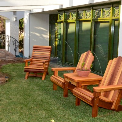 Ensenada Wood Easy Chair (Options: Standard Size, Mature Redwood, No Cushion, No Ottoman, Transparent Premium Sealant) with an Adirondack Vignette Settee. Photo Courtesy of El Estero Beach Resort of Ensenada, Baja.