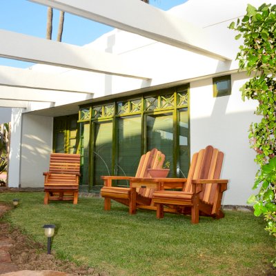 Ensenada Wood Easy Chair (Options: Standard Size, Mature Redwood, No Cushion, No Ottoman, Transparent Premium Sealant) with an Adirondack Vignette Settee. Photo Courtesy of El Estero Beach Resort of Ensenada, Baja.