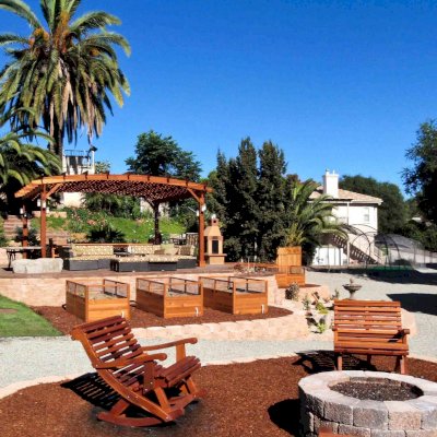 Ensenada Wooden Rocking Chair (Options: Extra Wide, California Redwood, No Cushion, Transparent Premium Sealant) and 16' x 20' Arched Pergola. Photo courtesy of Mr. M. Tomacelli of Fallbrook, CA.