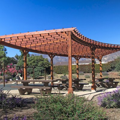 Fan Shaped Pergola Kit (Options: 35' x 16', Mature Redwood, With Roof Slats, No Electrical Wiring Trim Kit, 8-Post Anchor Kit for Concrete, No Ceiling Fan Base, 9.5' Posts, No Curtain Rods, Transparent Premium Sealant). Photo Courtesy of M. Roberts of Carpinteria, California.