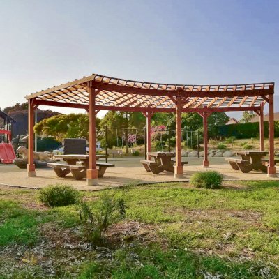 Fan Shaped Pergola Kit (Options: 22' x 25', California Redwood, With Roof Slats, No Electrical Wiring Trim Kit, 8-Post Anchor Kit for Concrete, No Ceiling Fan Base, 9.5' Posts, No Curtain Rods, Transparent Premium Sealant). Photo Courtesy of Vedic Education and Devotional Academy of Milpitas, California.