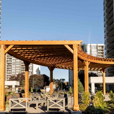 Fan Shaped Pergola Kit (Options: 38' x 14', California Redwood, With Roof Slats, 1 Electrical Wiring Trim Kit, 8-Post Anchor Kit for High-Wind, No Ceiling Fan Base, 10' Posts, No Curtain Rods, Transparent Premium Sealant). Photo Courtesy of A. Finnegan of Toronto, Ontario, Canada. 