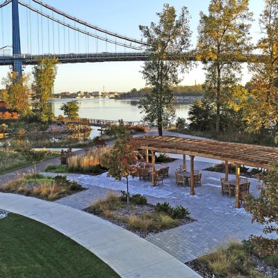 Fan Shaped Pergola Kit (Options: 50' x 14', California Redwood, Roof Slats at 18", No Electrical Wiring Trim Kit, 9-Post Anchor Kit for Concrete, No Ceiling Fan Base, 9.5' Posts, No Curtain Rods, Transparent Premium Sealant). Photo Courtesy of Metroparks Toledo of Toledo, OH.