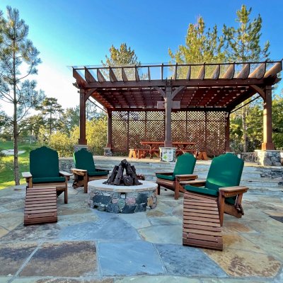 Folding Adirondack Ottomans (Options: Old-Growth Redwood, Transparent Premium Sealant) with Adirondack Folding Chairs. Photo Also Shows a Montvale Pergola with a Forever Picnic Table in the Background. Photo Courtesy of J. Brinkman of Castle Rock, Colorado.