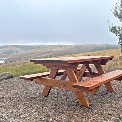 Forever Picnic Tables (Attached Benches) (Options: 6' L, 34 1/2" W, Attached Side Benches, Mature Redwood, Standard Tabletop, Rounded Corners, Custom Engraving, No Diamenter Umbrella Hole, Transparent Premium Sealant). Photo Courtesy of D. Tibbetts of Bodega Bay, CA.