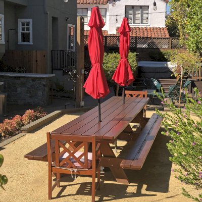 Forever Picnic Table (Attached Benches) (Options: 14' L x 34 1/2", Old-Growth Redwood, Standard Tabletop, Rounded Corners, 2" Umbrella Hole, Transparent Premium Sealant). Photo Courtesy of S. Chipman of Oakland, CA.