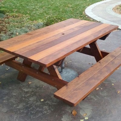 Forever Picnic Tables (Attached Benches) (Options: 6' L, 40 1/4" W, Attached Side Benches, Old-Growth Redwood, Standard Tabletop, Slightly Rounded Corners, 1 5/8" Umbrella Hole, Transparent Premium Sealant). Photo Courtesy of T. Atkinson of Fort Collins, CO.