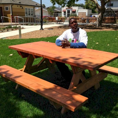Forever Picnic Tables (Attached Benches) (Options: 6' L, 34 1/2" W, Side Benches, California Redwood, Standard Tabletop, SlightlyRounded Corners, No Umbrella Hole, Transparent Premium Sealant). Photo Courtesy of Pogo Park of Richmond, CA (www.pogopark.org).