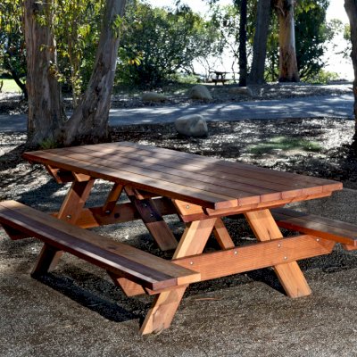 Forever Picnic Tables (Attached Benches) (Options: 8' L, 34 1/2" W, Side Benches, California Redwood, Standard Tabletop, Squared Corners, No Umbrella Hole, Transparent Premium Sealant). Located at El Capitan State Beach near Santa Barbara, CA part of a 90 table installation completed in 2015.