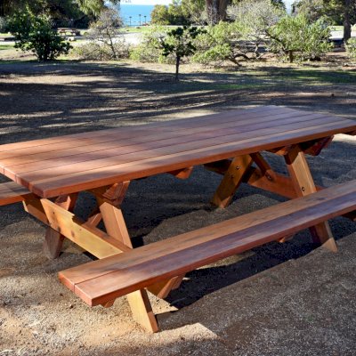 Forever Picnic Tables (Attached Benches) (Options: 8' L, 34 1/2" W, Side Benches, California Redwood, Standard Tabletop, Squared Corners, No Umbrella Hole, Transparent Premium Sealant). Located at El Capitan State Beach near Santa Barbara, CA part of a 90 table installation completed in 2015.