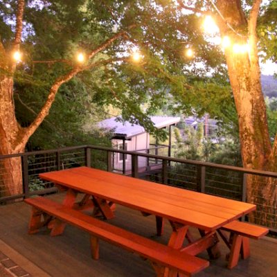 Custom Forever Picnic Tables (Unattached Benches) (Options: 10' L, 34 ½in W, Mature Redwood, 1 Full Length Bench Per Side, Standard Tabletop, Slightly Rounded Corners, No Umbrella Hole, Transparent Premium). Using Two Tongue & Groove Matching 5 3/4" Boards to Create the Appearance of an 11 1/2" Wide Board Construction. Photo courtesy of E. Johnson of Eugene, Oregon.