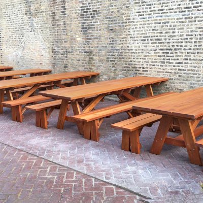 Forever Picnic Tables (Unattached Benches) (Options: 10', 34 ½in W, Side Benches, Mature Redwood, 1 Full Length Side Bench Per Side, Standard Tabletop, Squared Corners, 2" Umbrella Hole, Transparent Premium Sealant). Standard design is with 5 3/4" wide boards. The tabletops in this photo were built for the restaurant by request using bookend construction (where 2 standard width 5 3/4" wide boards are tongue and grooved together to appear as one wider 11 1/2" wide board). If you would like this effect for your tables, just add a note saying want bookend detail added to your order (no extra charge to do this). Photo courtesy of M. Piekarz of Chicago, IL.