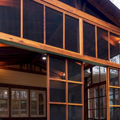 Forever Porch Pavilion (Options: 20' L x 20'-9" W, California Redwood, 2-Post Anchor Kit for High-Wind, No Electrical Wiring Trim, with 2 Fascia Boards for Gutters, 12 ft Posts Height, No Post Decorative Trims, 1 Ceiling Fan Base, No Curtain Rods, with Privacy Panels, Screened Sliding Doors and Fixed Screen Panels, Transparent Premium Sealant). Photo Courtesy of J. Pegg of Cordova, TN.