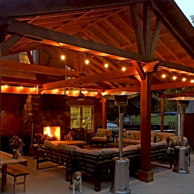 Custom Forever Porch Pavilion (Options: 30' L x 22' W, Douglas-fir, 5-Post Anchor Kit for Concrete, 1 Ceiling Fan Base, Transparent Premium Sealant). Because of the depth of the pavilion, posts up against the house were used for structural reasons. Photo Courtesy of A. Offutt of New Albany, Indiana.