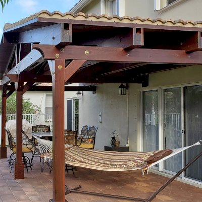 Forever Porch Pavilion (Options: 12' L x 25' W, California Redwood, 3-Post Anchor Kit for High-Wind, No Electrical Wiring Trim, 9ft Posts Height, No Ceiling Fan Base, No Curtain Rods, No Privacy Panels, Transparent Premium Sealant). Photo Courtesy of Carol Varela of Florida.