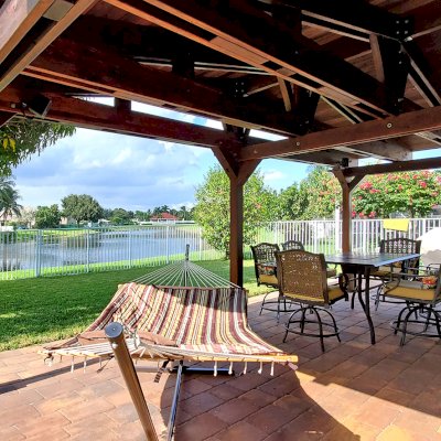 Forever Porch Pavilion (Options: 12' L x 25' W, California Redwood, 3-Post Anchor Kit for High-Wind, No Electrical Wiring Trim, 9ft Posts Height, No Ceiling Fan Base, No Curtain Rods, No Privacy Panels, Transparent Premium Sealant). Photo Courtesy of Carol Varela of Florida.