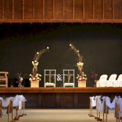 Wedding at the Barn. Hennell Wooden Garden Bench (Options: 4 ft, Douglas-fir, Custom Cushion, Custom Engraving, Transparent Premium Sealant). Photo also shows two custom planter boxes in Douglas-fir, Unfinished. 