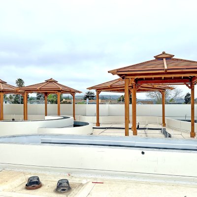 Hot Tub Enclosure Kits / Hot Tub Pavilion (Options: 10' x 10' & 12' x 12', Shiplap Roof Out of California Redwood and the Rest of the Structure in Douglas-fir, Without Skylight, 1 Ceiling Fan Base, Without Windows, 4 Curtain Rod, 4-Post Kit for Concrete, Transparent Premium Sealant). Pavilions are installed on the rooftop of La Bahia Hotel & Spa in Santa Cruz, CA.