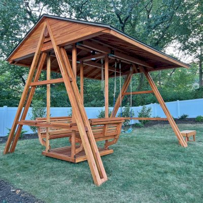 Jean's Ultimate Swing Set (Options: Mosaic Douglas-Fir with Mosaic Mature Redwood Roof, Ensenada Face to Face Seats, with 1 Co-Polymer Standard & 1 Full Bucket Swing Seat in Green Color, with Beverage Armrests, Extra Wide Roof, with Kid's Platform/Side Table, No, Engraving, Transparent Premium Sealant). Photo Courtesy of M. & V. Zayas of Clifton, NJ.