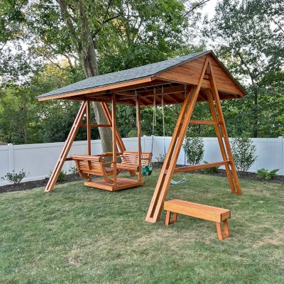 Jean's Ultimate Swing Set (Options: Mosaic Douglas-Fir with Mosaic Mature Redwood Roof, Ensenada Face to Face Seats, with 1 Co-Polymer Standard & 1 Full Bucket Swing Seat in Green Color, with Beverage Armrests, Extra Wide Roof, with Kid's Platform/Side Table, No, Engraving, Transparent Premium Sealant). Photo Courtesy of M. & V. Zayas of Clifton, NJ.