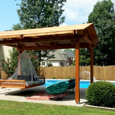 Jhoola Day Bed Swing Sets (Options: 7' L, 60" W, Seat Only, California Redwood, All Beam Hanging Hardware, Add 3 Railings (North, South and extra one, East or West), Day Bed Style, No Cushion, Transparent Premium Sealant). Also shows a Del Norte Pavilion.