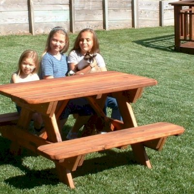 Kid Size Wood Picnic Table (Attached Benches) (Options: Mature Redwood, No Umbrella, Standard Top, Transparent Premium Sealant). Custom design: rounded corners and thickness of the bars of the table are thinner than standard. Photo Courtesy of Rachel & Tim McAllister of Santa Rosa, CA.