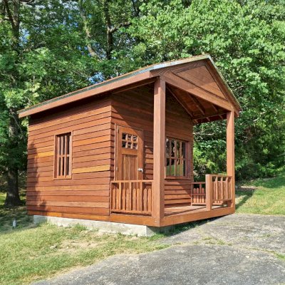 Kid's Backyard Cabin (Options: 14ft L x 10ft W, 8ft Wall H, Douglas-fir [Exterior Siding & Roofing in California Redwood by Custom Request], 4ft Front Porch Size [Included in the Overall Length], Interior Tongue & Groove Flooring, Shiplap Roof, Coffee-Stain Premium Sealant). Photo Courtesy of T. ONeill of Kimberling City, MO.