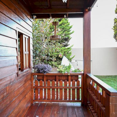 Kid's Backyard Cabin (Options: 12ft L x 8ft W, 7ft Wall H, Douglas-Fir, 4ft Front Porch Size [Included in the Overall Length], Interior Decking, Transparent Premium Sealant). Photo shows structure recently resealed after 6 years of loving service.