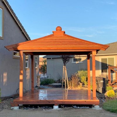 Kikue's Pavilion (Options: 12 ft L x 10 ft W, Standard Wood Roof, California Redwood, No Electrical Wiring Trim, with Floor by Custom Request, 4-Post Anchor Kit for Concrete, Transparent Premium Sealant). Photo Courtesy of R. Cooper of Rio Vista, California.