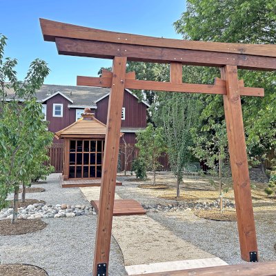 Kikue's Tea House (Options: 8 ft L x 8 ft W, 7' Wall Height, Shiplap Roof, Mature Redwood, No Electrical Wiring Trim, No Deck [Installed on Existing Deck], Transparent Premium Sealant). Photo Also Shows a 6' Forever Foot Bridge and a Custom Torii Gate. Photo Courtesy of C. Szumski of Sonoma, CA.