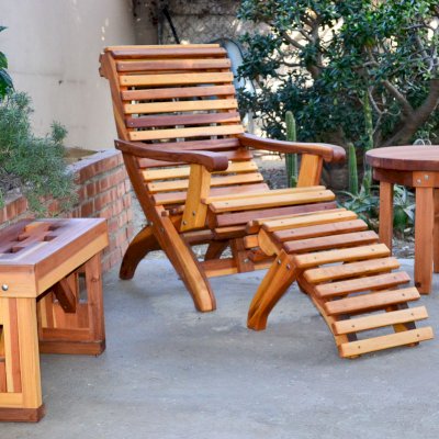 Lighthouse Garden Bench (Options: 2 1/2 ft L x 12 1/2 inches W, 18 1/2 inches H, California Redwood, No Cushion, No Engraving, Transparent Premium Sealant). Ensenada Easychair with Ottoman & Round Side Table in background. 